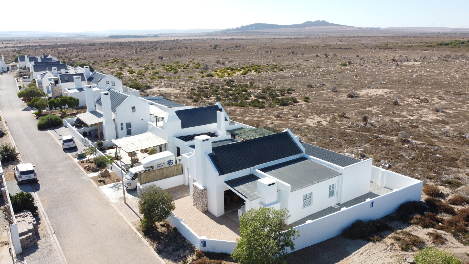 Aerial view of the whitewashed home and garden